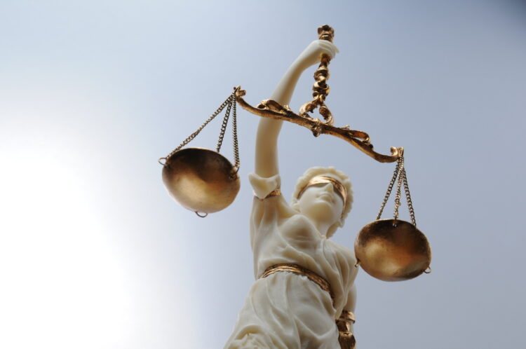 Lady Justice Representing Wage and Hour Law Enforcement in NJ A statue of Lady Justice holding scales, symbolizing fairness and the enforcement of wage and hour laws in New Jersey.
