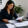 Employee reviewing workplace documents while considering whether to contact an employment lawyer