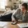 Employee on medical leave receiving repeated work calls while reviewing FMLA paperwork.