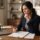 Employee carefully reviewing a severance agreement and release of employment claims before signing.